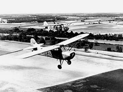 An olive-drab Aeronca L-16 liaison aircraft of the U.S. Air Force in flight