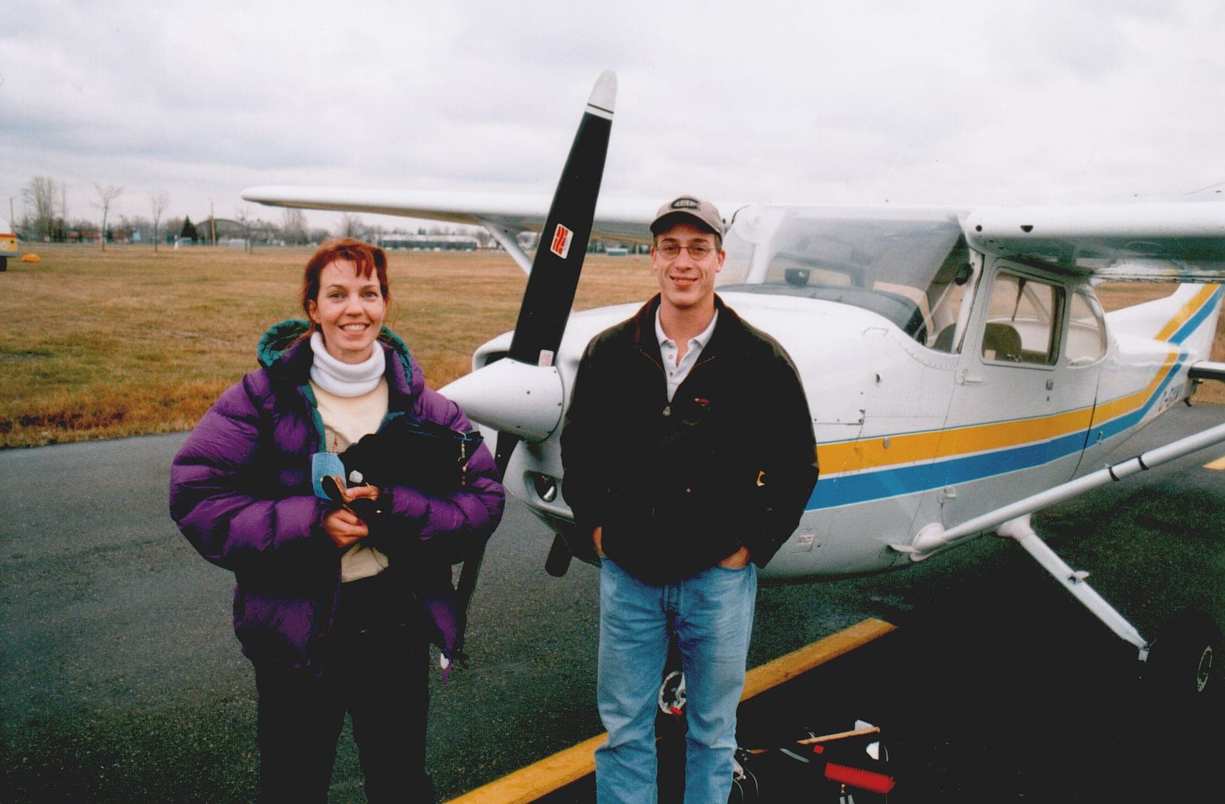 A flight instructor and student beside a Cessna 172 training aircraft