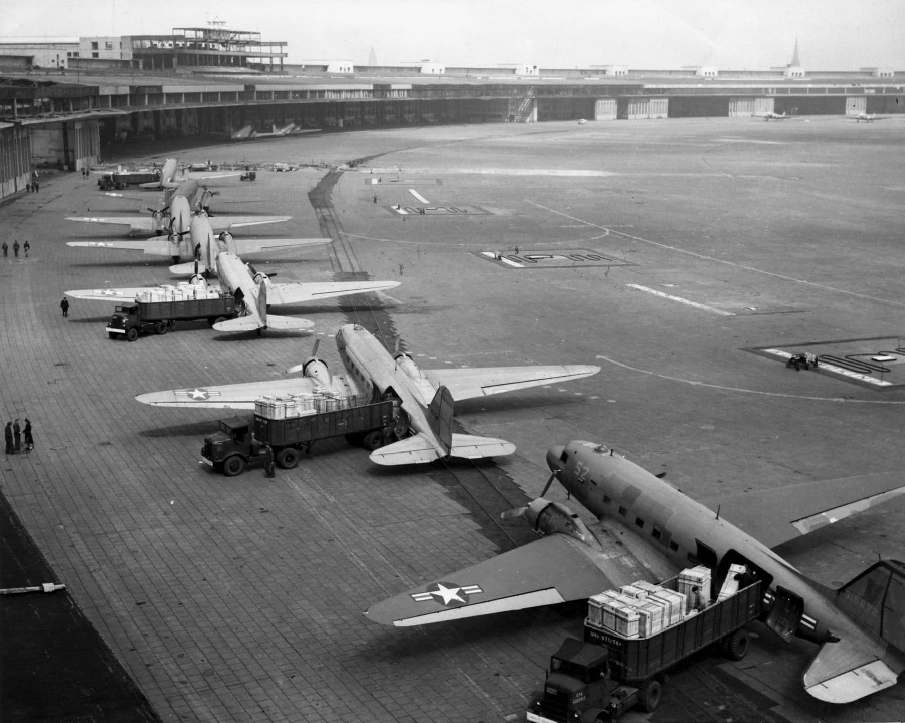 U.S. Navy R4D and U.S. Air Force C-47 transports unloading at Tempelhof Airport during the Berlin Airlift, 1948