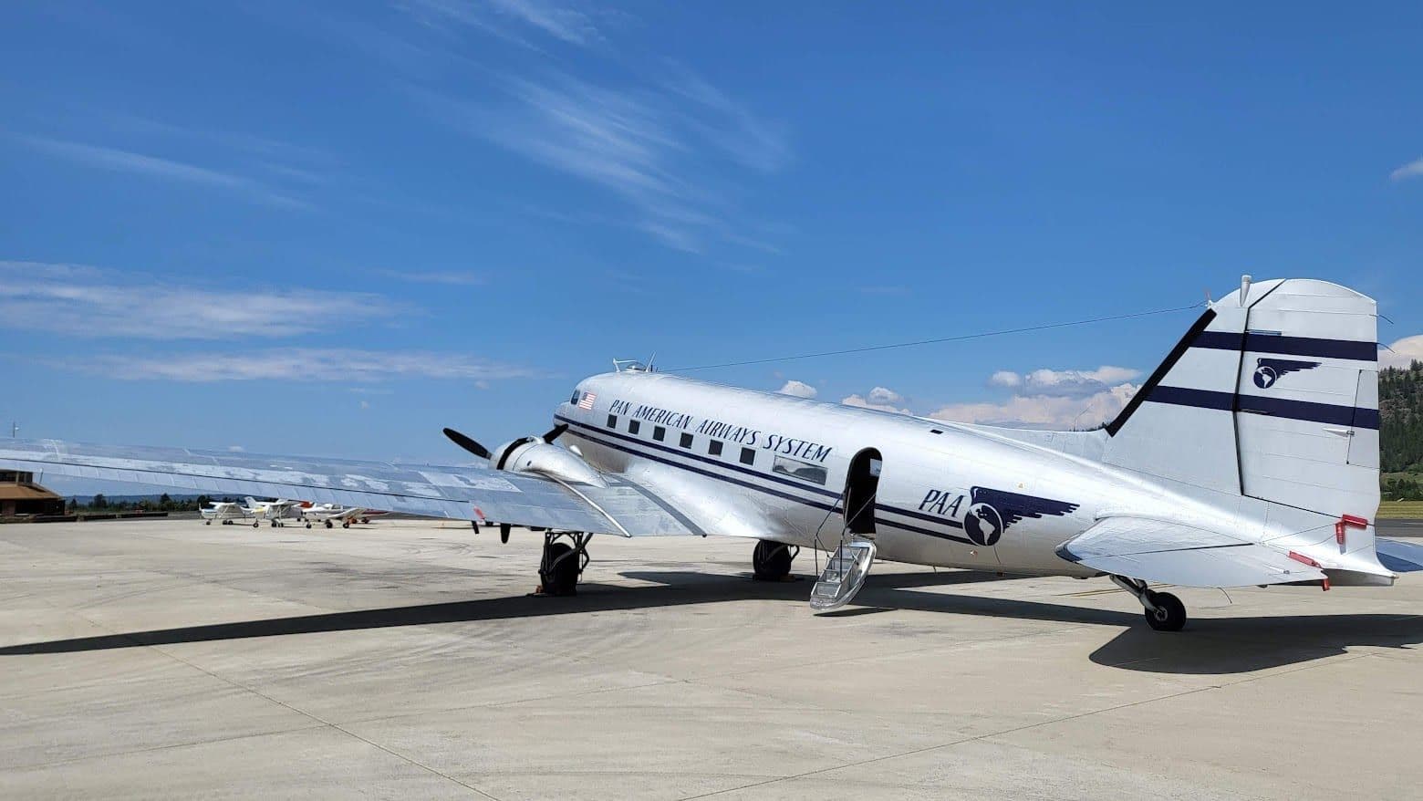 A restored civil Douglas DC-3 in blue and white airline livery on the ramp at the Historic Flight Foundation, Spokane, Washington