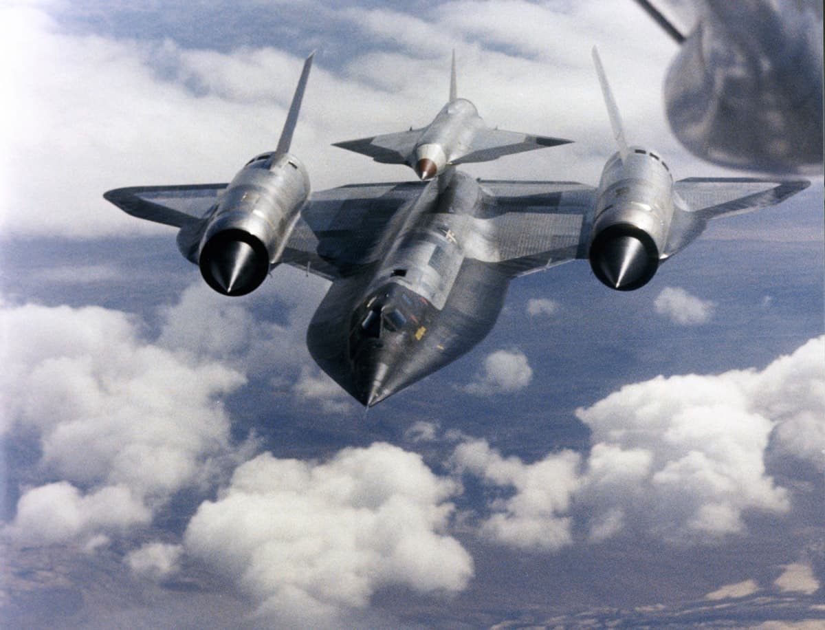 The two-seat M-21 mothership in flight with a D-21 reconnaissance drone mounted on its dorsal pylon