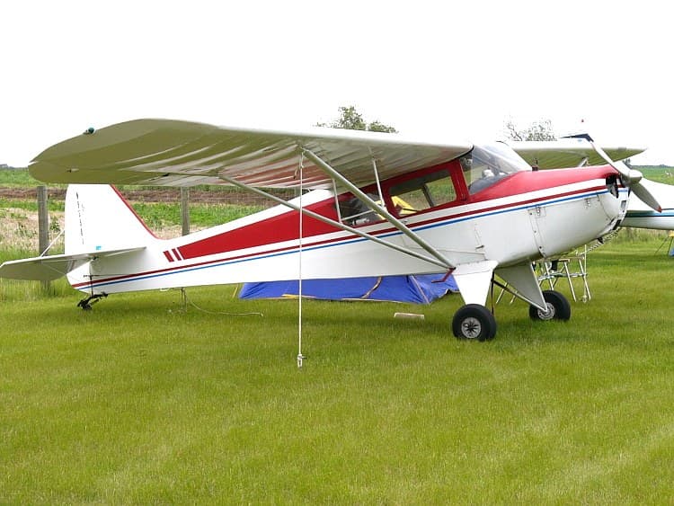 A Taylorcraft BC-12D, registration N9558, parked on grass