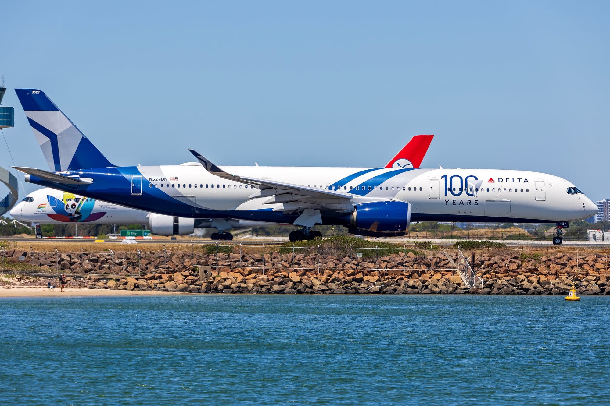 Delta Airbus A350-900 N527DN in the 100 Years centenary livery, taxiing at Sydney Airport on 8 January 2026.