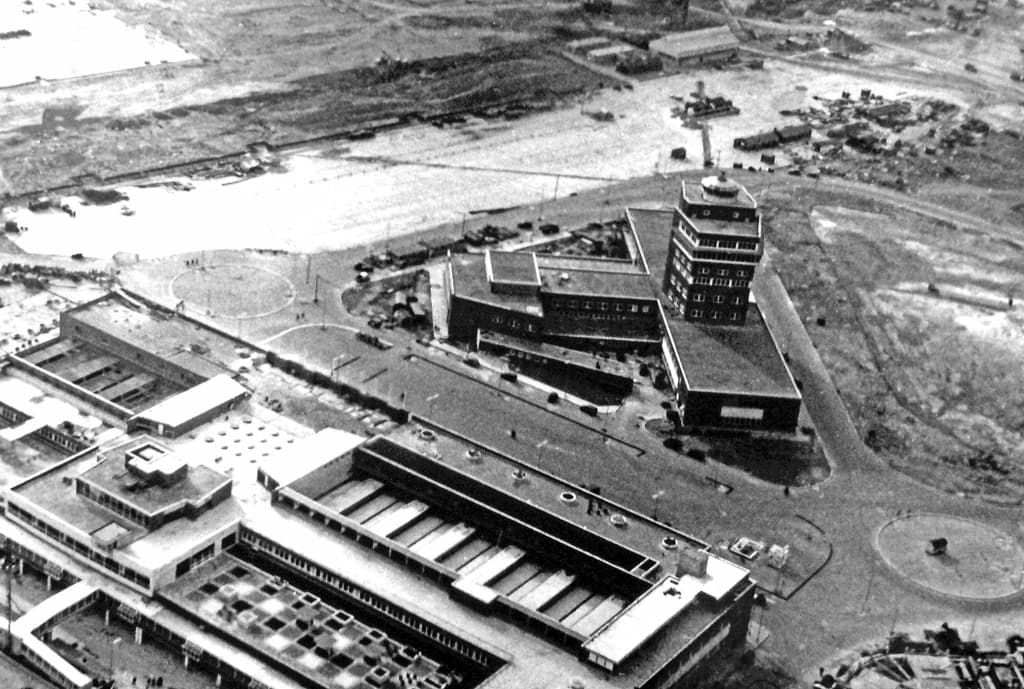 Heathrow's central area under construction in April 1955, with the new control tower and the Europa and Queens Buildings taking shape