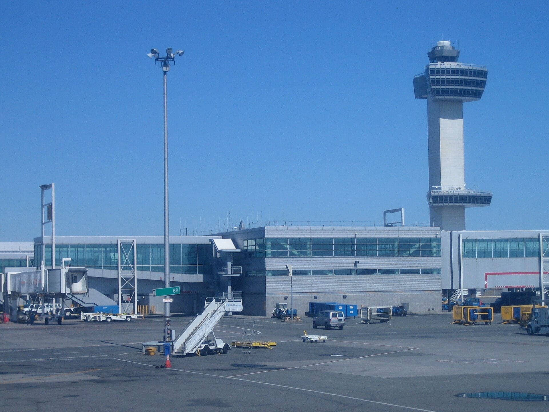 The 321-foot control tower that opened in 1994, rising behind a terminal pier with airstairs on the apron