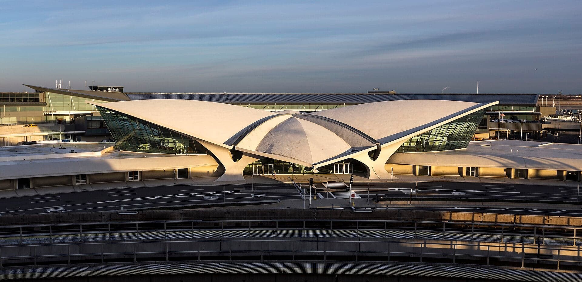 The TWA Flight Center in January 2015, closed and awaiting conversion, its winged roof silhouetted in low evening light above the AirTrain tracks