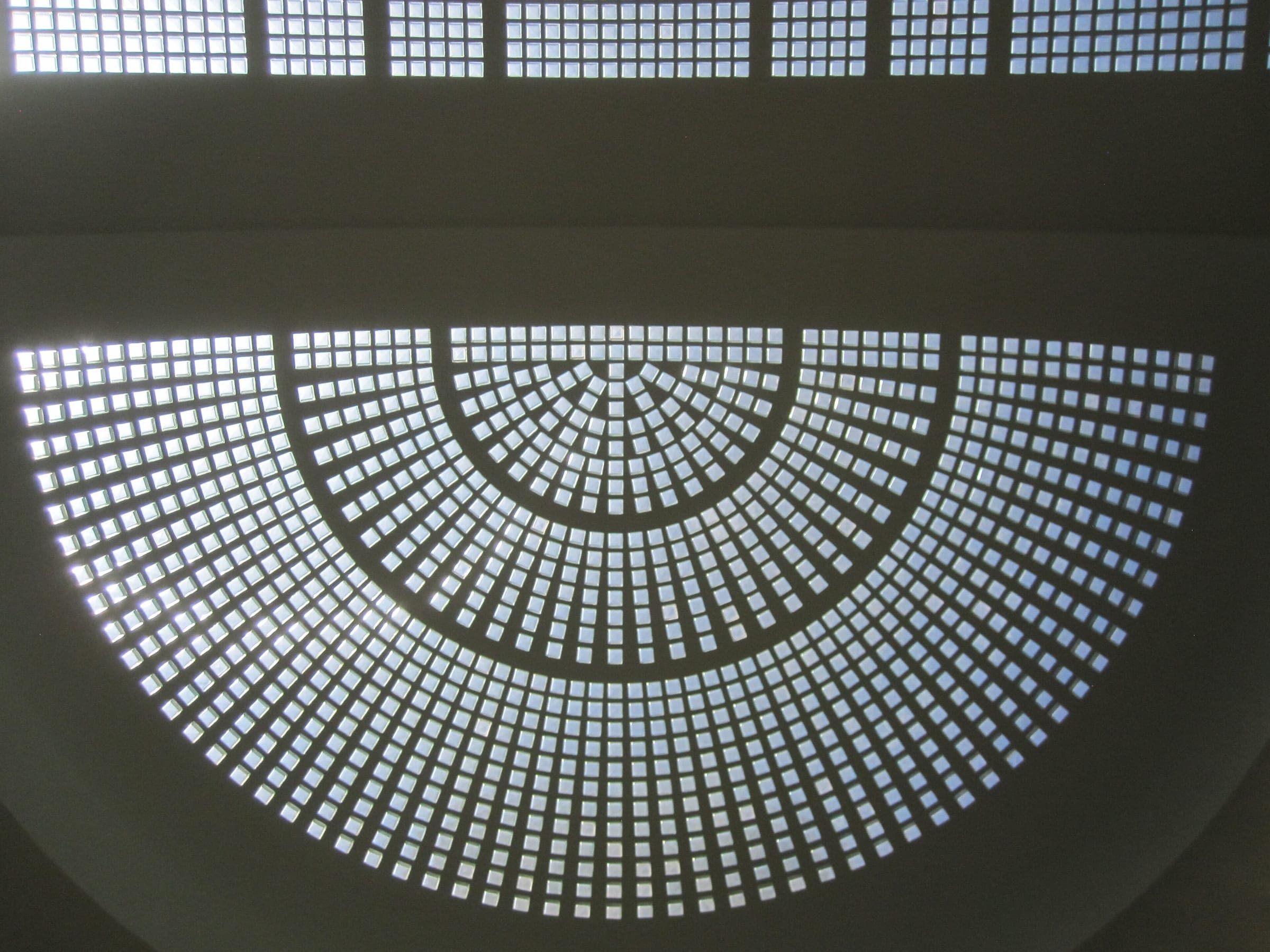 The glass-block dome of the rotunda inside the 1937 terminal, a half-circle of square lights radiating from the centre
