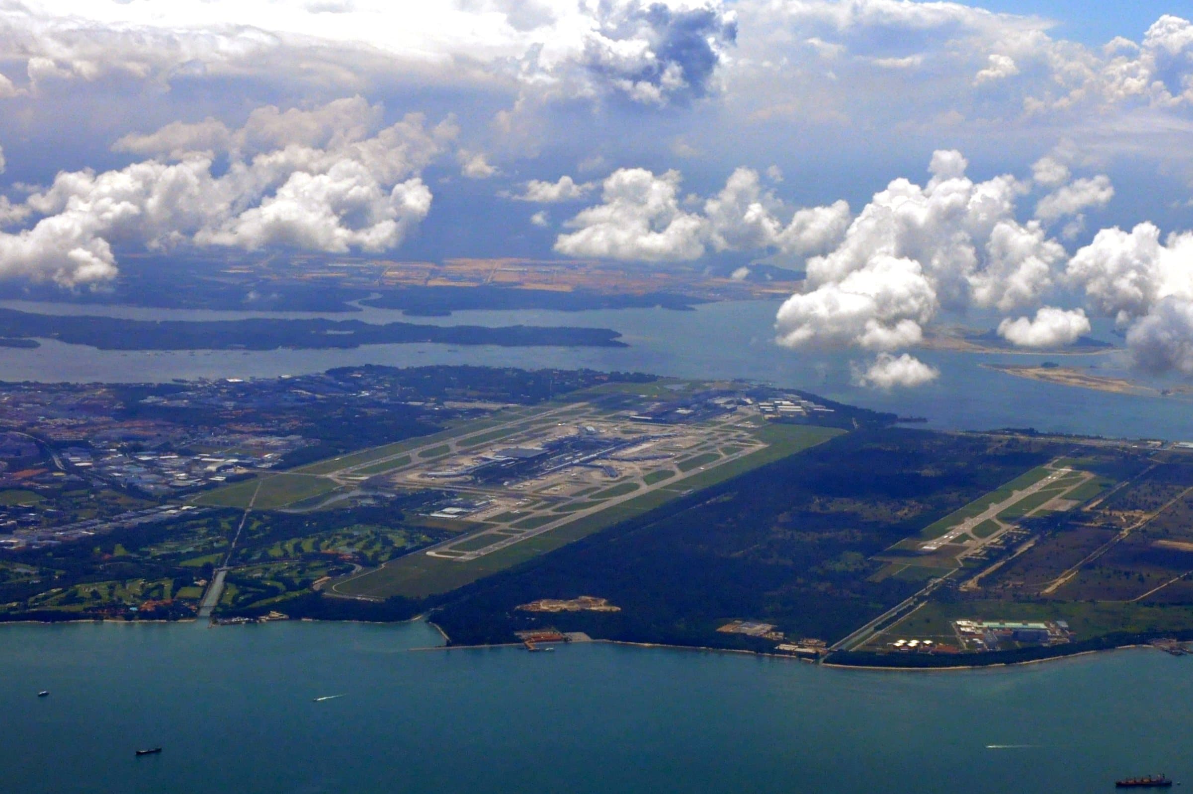 Changi from the air in 2011: its parallel runways on the eastern tip of Singapore, with Changi Air Base alongside and the sea beyond