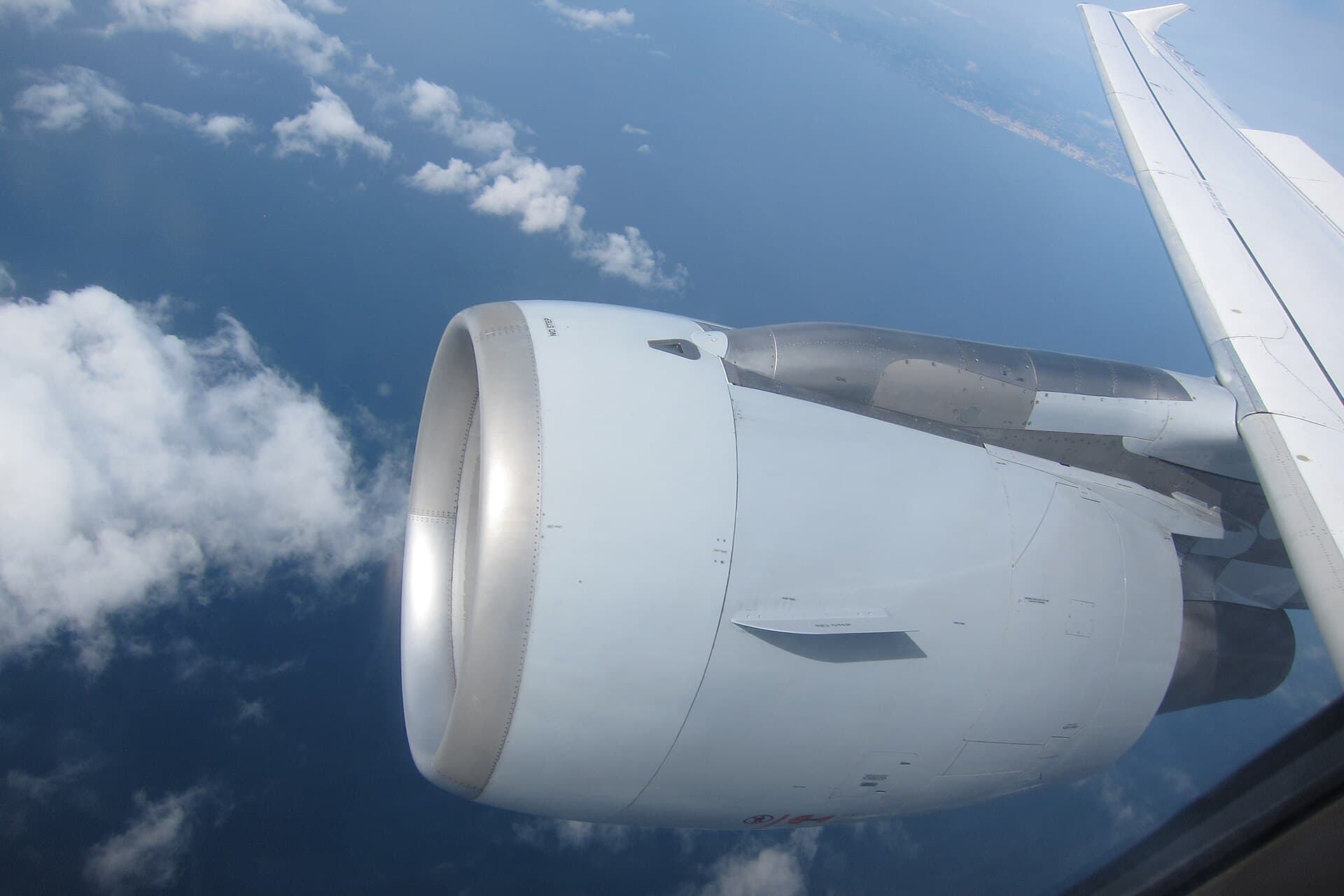 A CFM56 under the wing of a Lufthansa Airbus A320 in cruise, seen from a cabin window