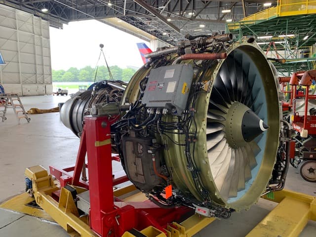 A Delta Air Lines CFM56-7B26 on a maintenance stand in a hangar at Atlanta