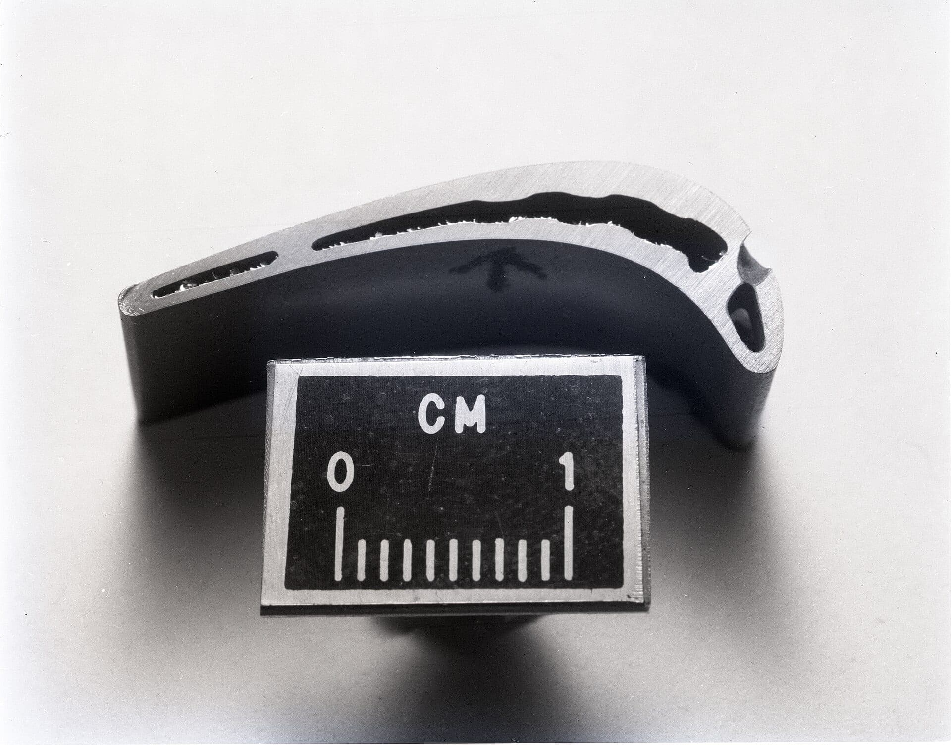 A 1979 photograph of a sectioned JT9D blade shown at twice life size beside a one-centimetre scale