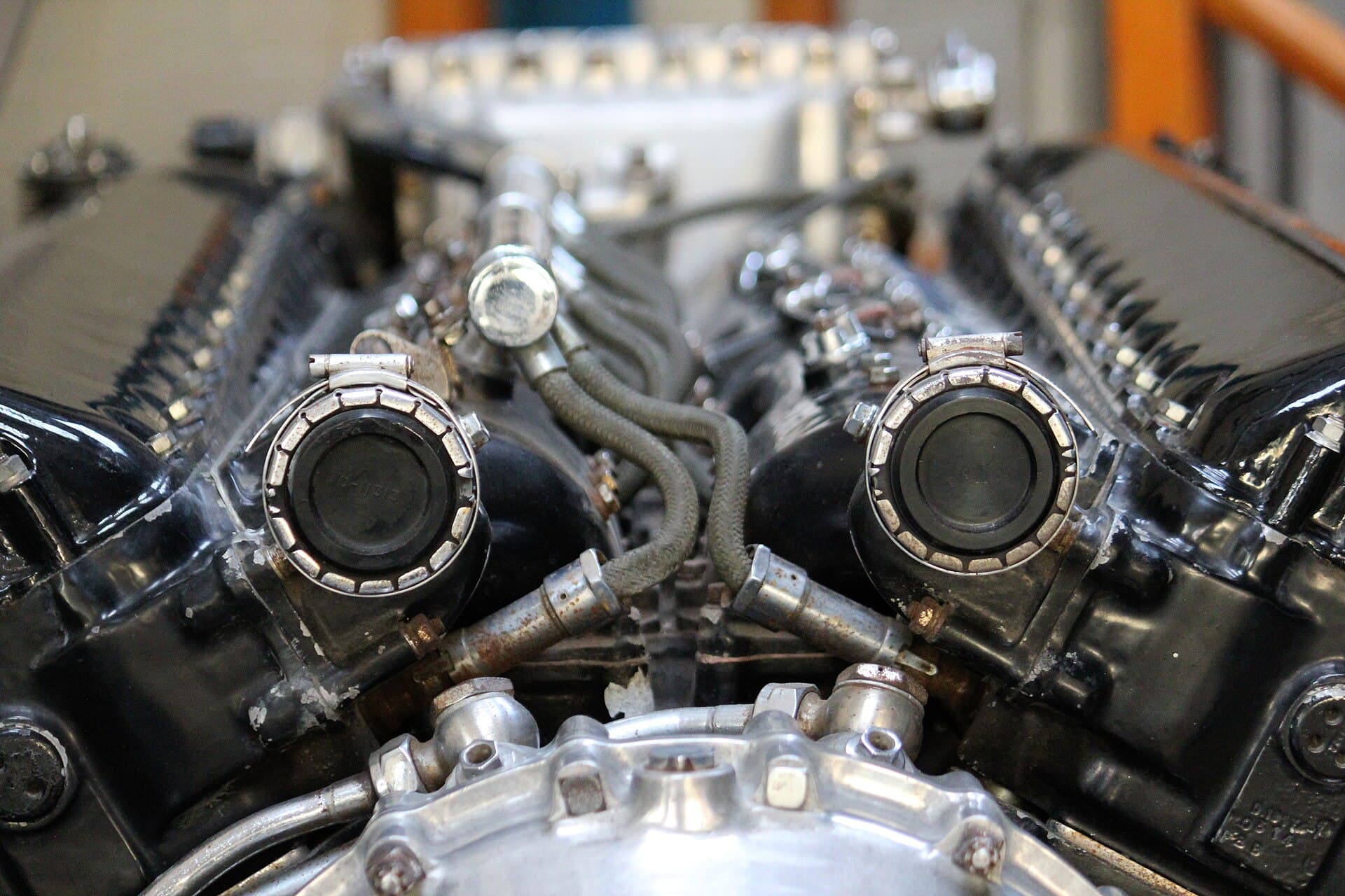 Looking down into the vee of a Merlin 61 between the cylinder banks, showing the blanked induction elbows and the shielded ignition harness