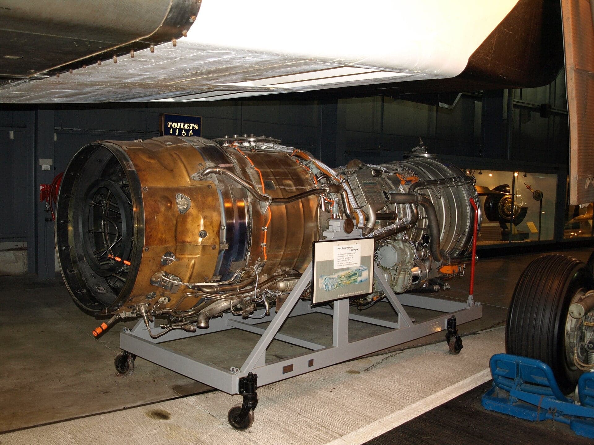 An Olympus 593 on its stand beneath the wing of Concorde 002 at the Fleet Air Arm Museum, Yeovilton
