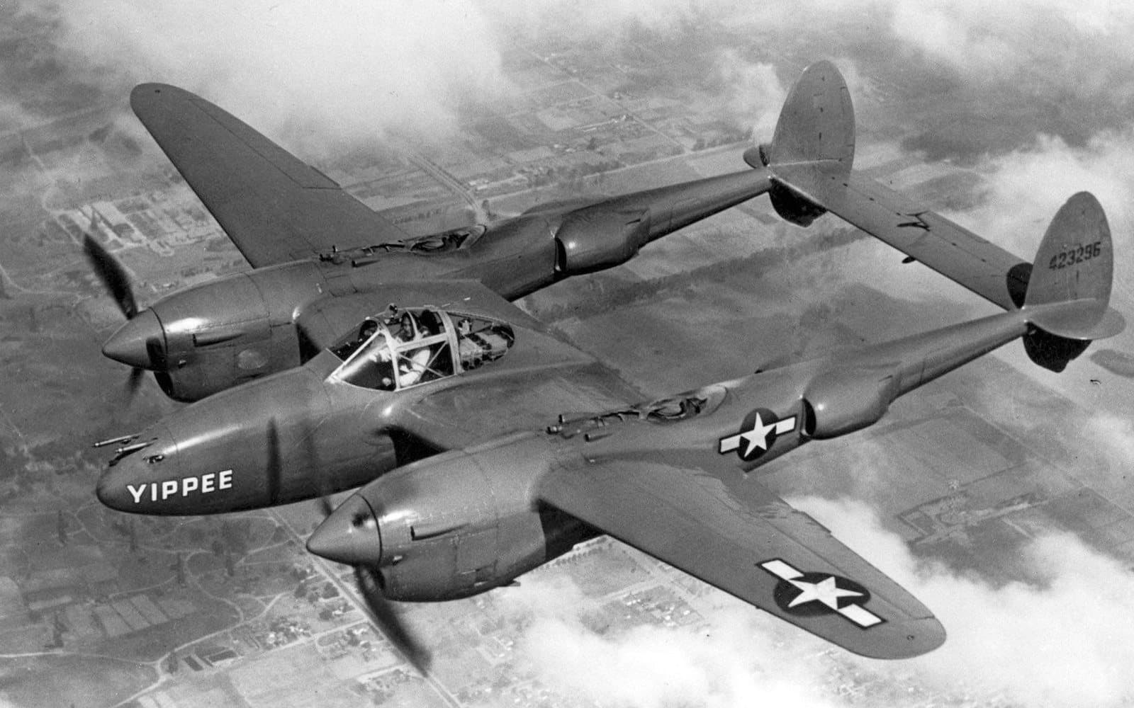 The polished Lockheed P-38J Lightning 'Yippee' in flight, showing its twin booms and central nacelle