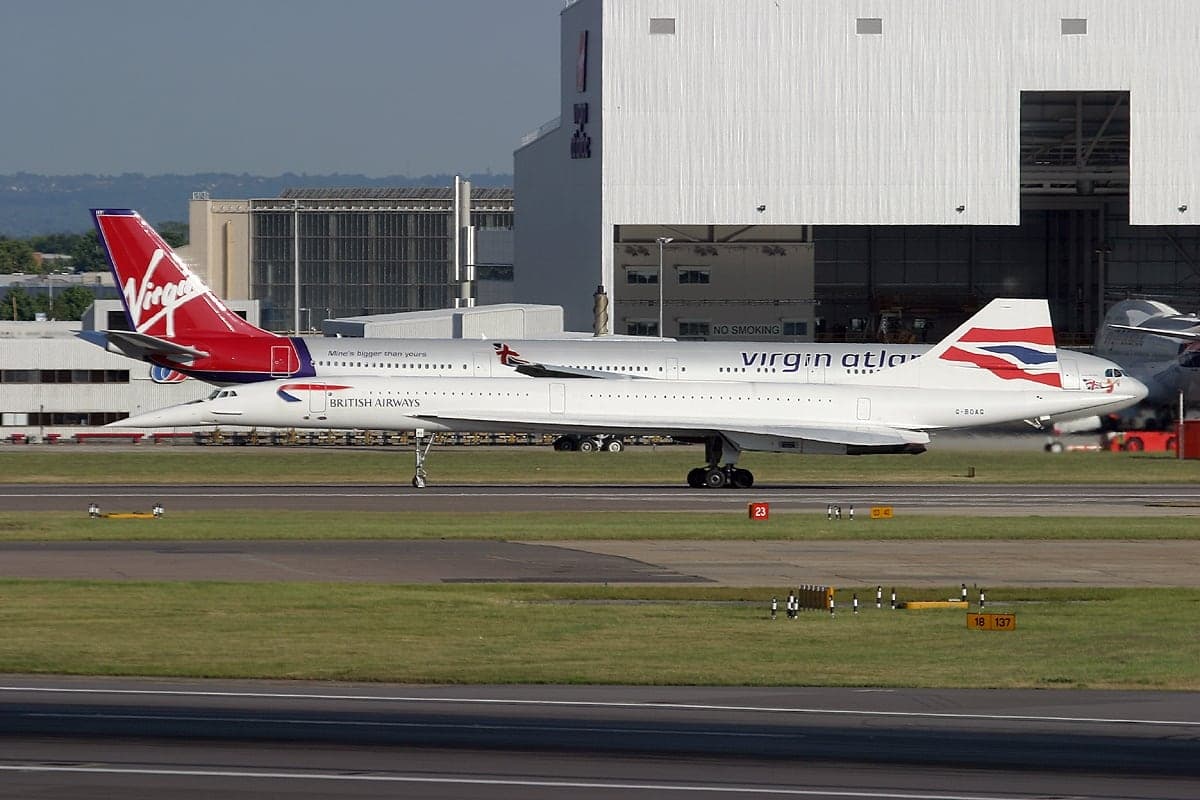 A British Airways Concorde taxiing past a Virgin Atlantic A340-600 before departing as BA001 to New York on 12 June 2003, months before retirement